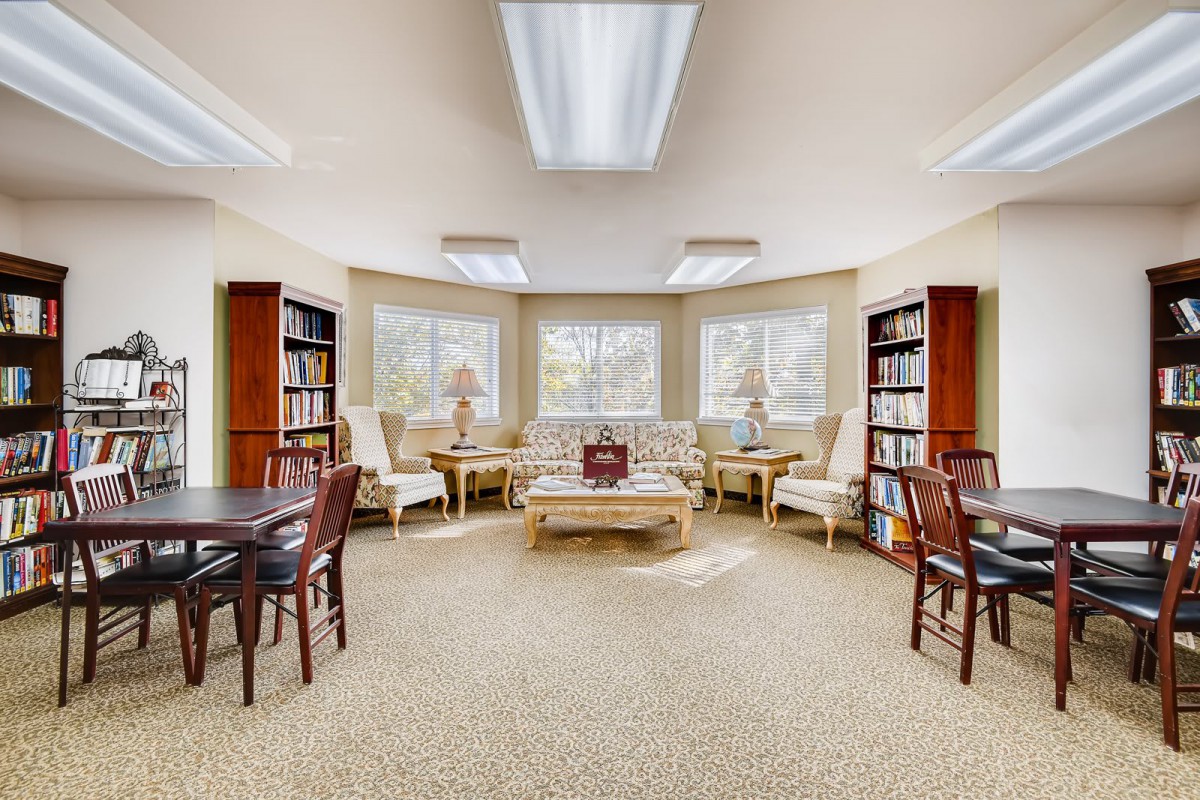 A cozy library reading area with comfortable seating and ample natural light.