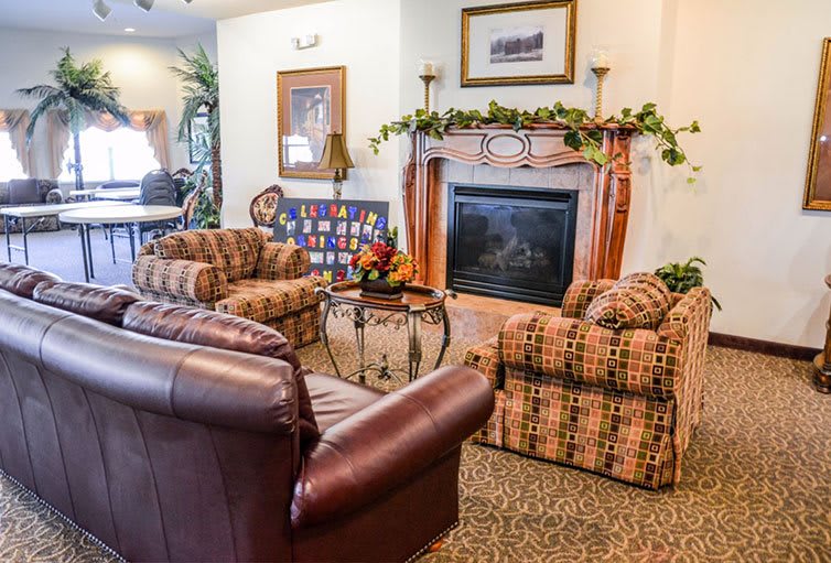 A cozy living room featuring a fireplace and comfortable seating arrangements.