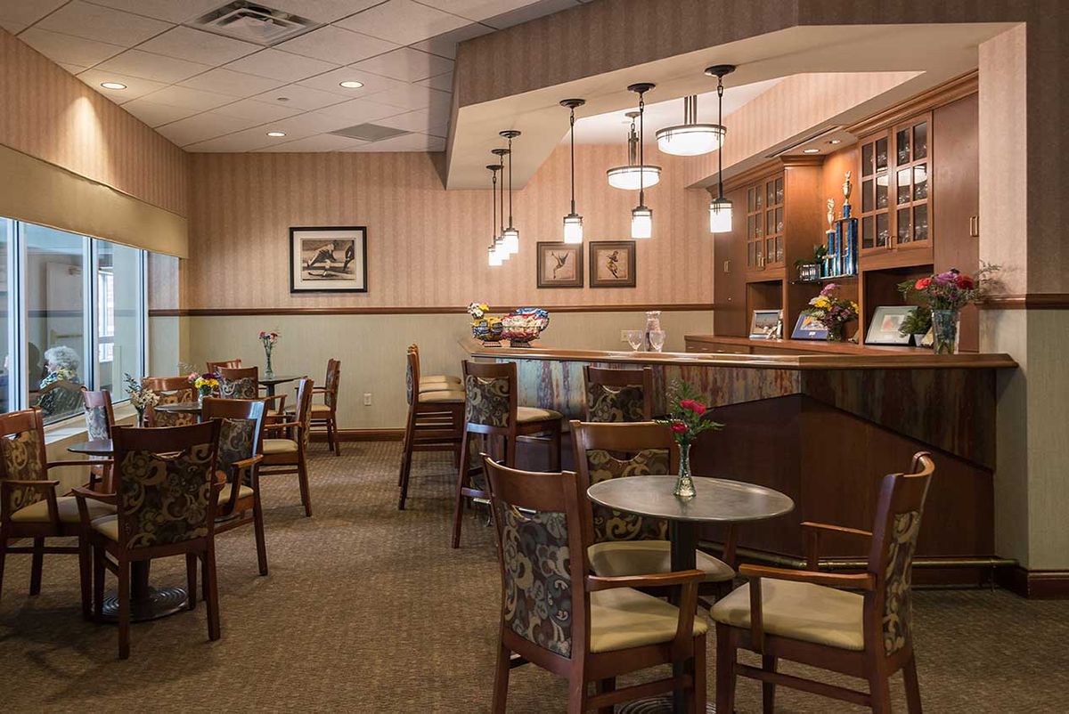 Cozy restaurant interior with tables and chairs arranged for dining.