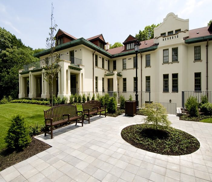 A historic villa surrounded by a landscaped garden.