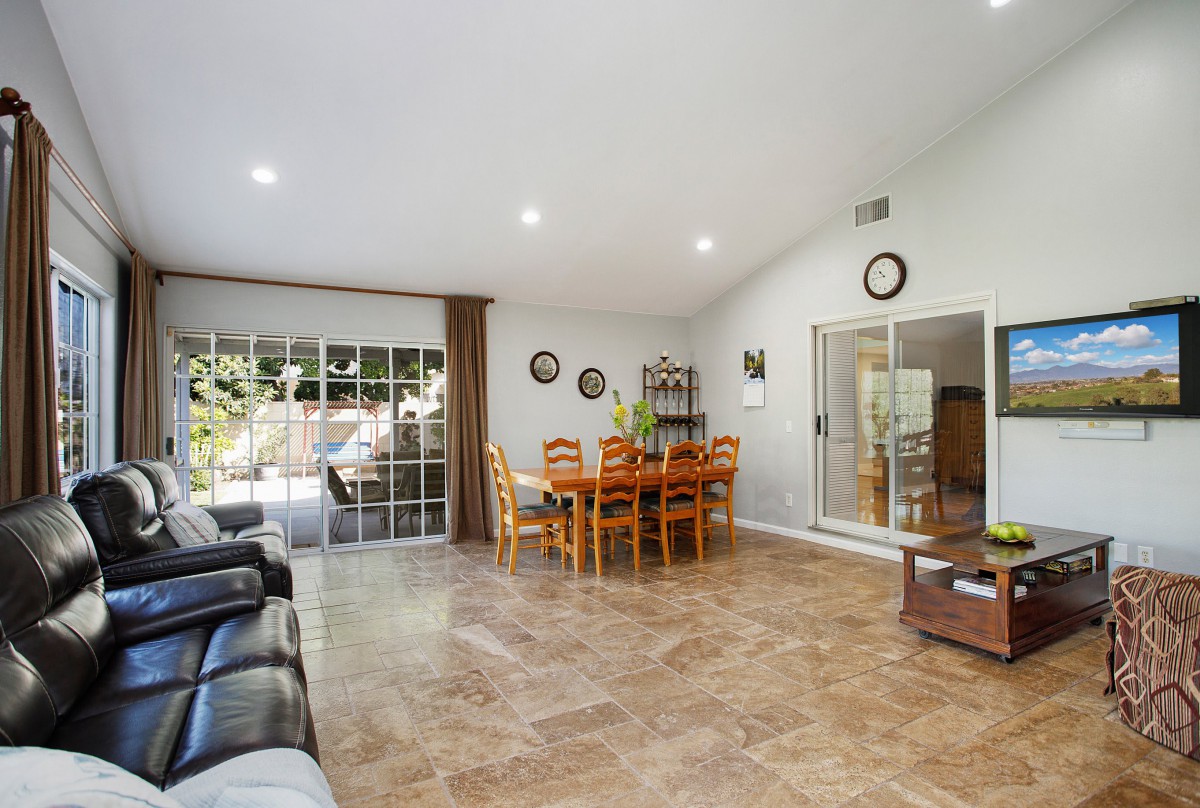 Spacious living and dining area with tile flooring and wide sliding glass doors for natural light.