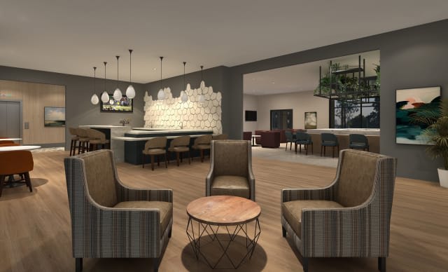 A stylish hotel lounge featuring a comfortable seating area and modern bar.