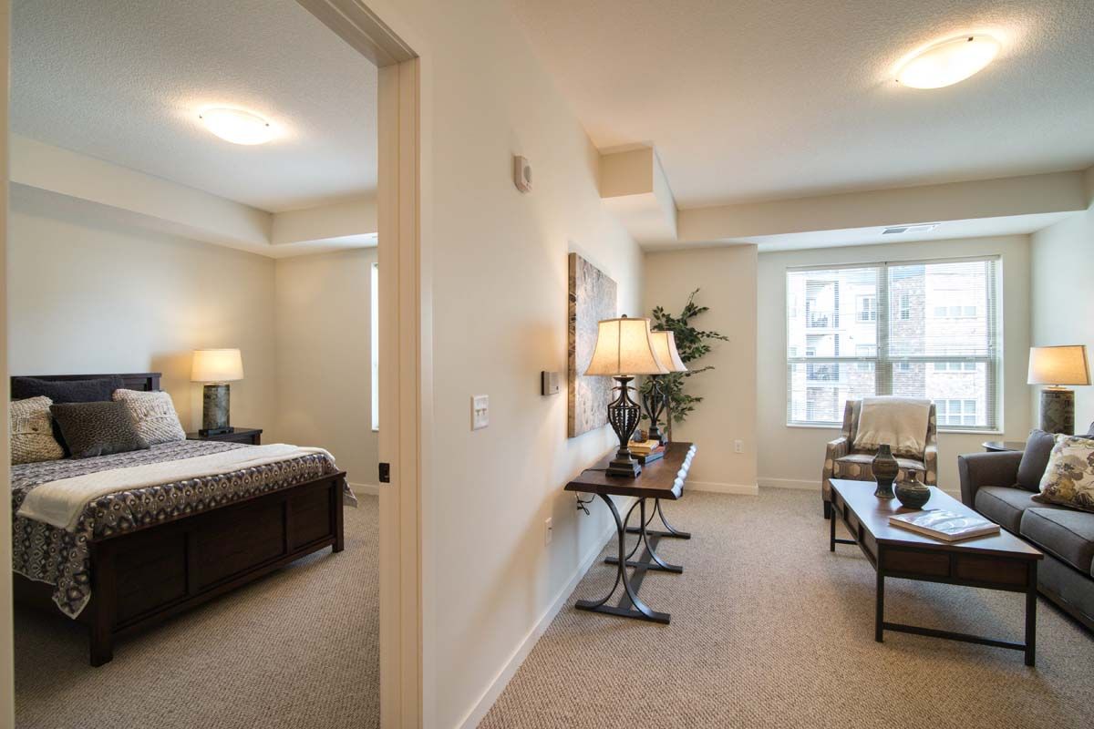 A cozy apartment interior featuring a bedroom and living area with elegant furnishings.