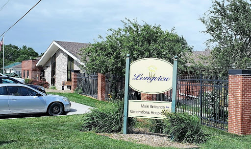 A welcoming entrance to a residential community, featuring well-maintained landscaping and signage.