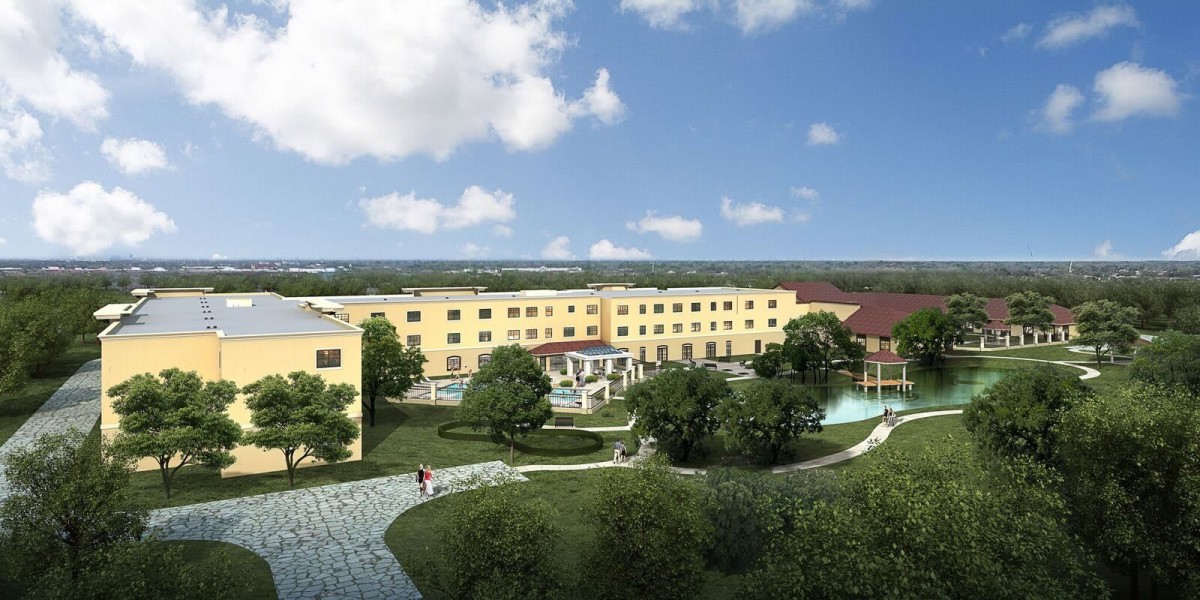 A scenic view of a hotel surrounded by gardens and pathways under a clear blue sky.
