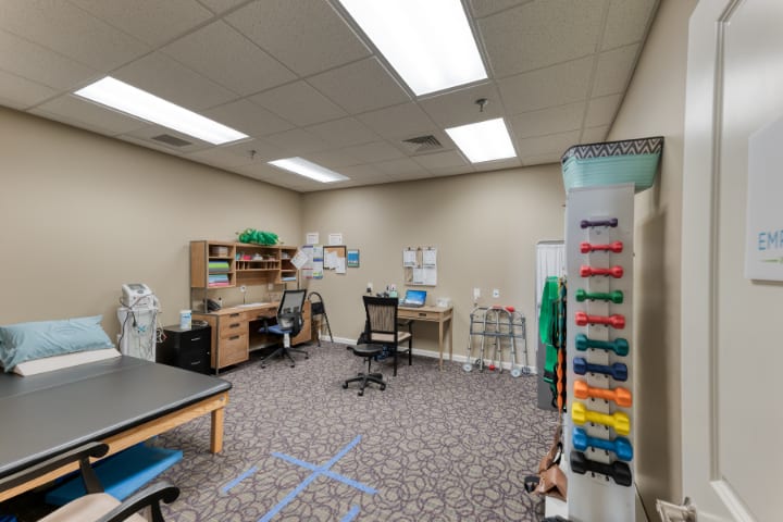 An organized office space with desks, chairs, and computer equipment.