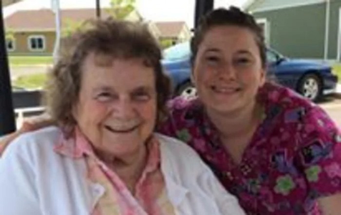 Two smiling individuals enjoying time together outdoors.