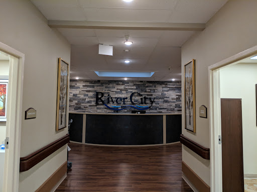 A view of the River City reception area, showcasing modern decor and a welcoming ambiance.