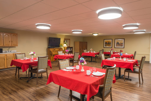 A cozy dining area set up with red tablecloths, ready for guests.