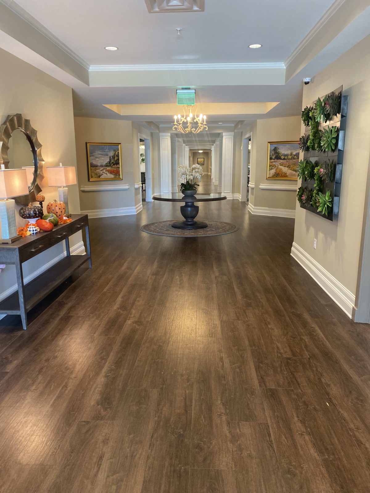 A beautifully decorated hallway with wooden floors and elegant furnishings.