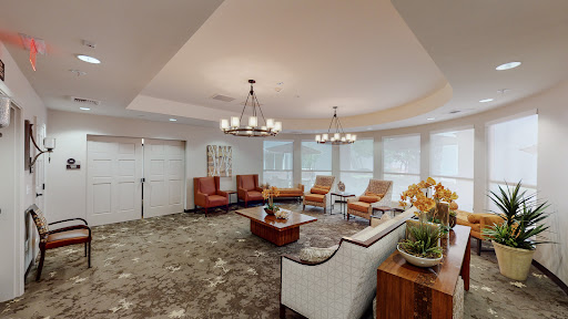 A cozy and modern lounge area featuring stylish seating and elegant lighting.