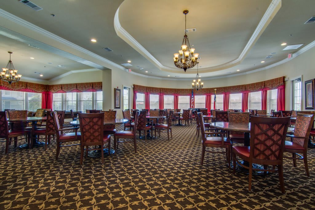 Spacious dining area with elegant decor and lighting.