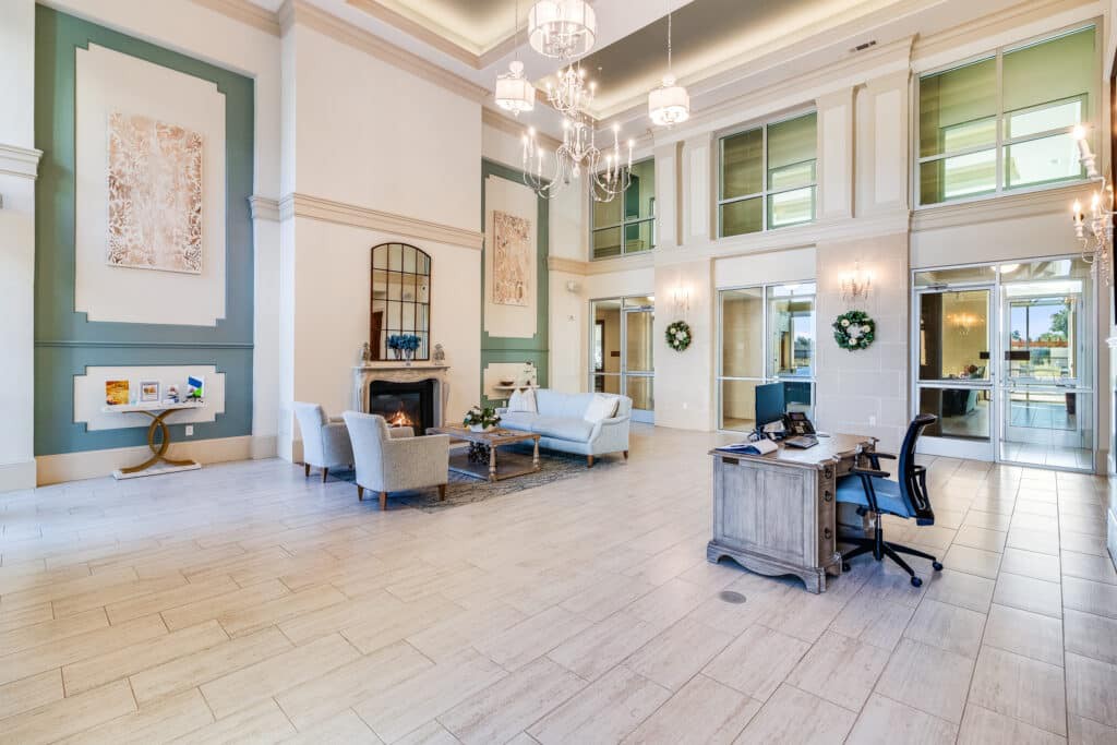 A spacious and elegantly designed lobby with chandeliers, comfortable seating, and modern decor.
