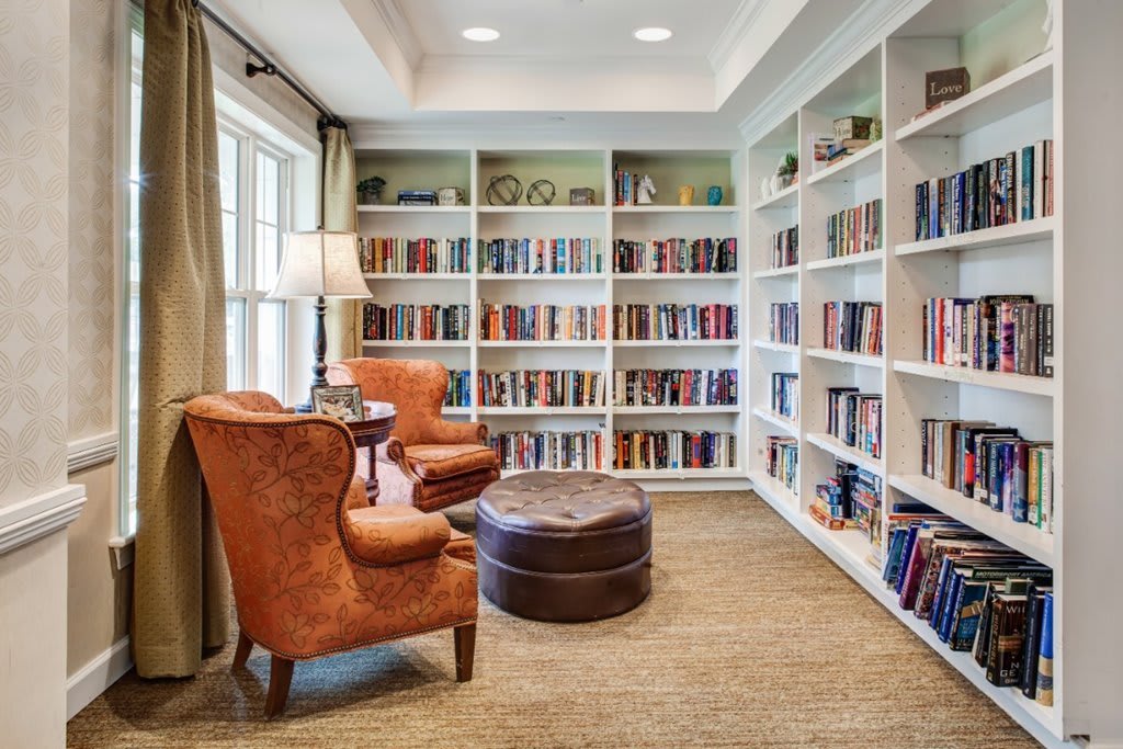 A cozy home library with bookshelves and comfortable armchairs.