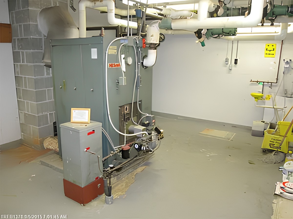 An industrial boiler system with surrounding pipes in a mechanical room.