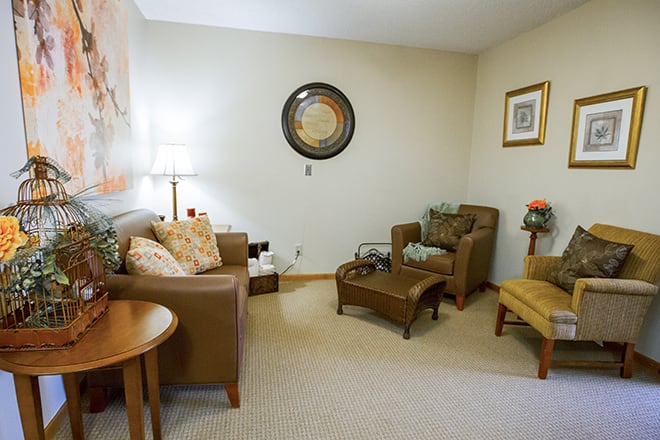 A cozy living room with comfortable seating and elegant decor.