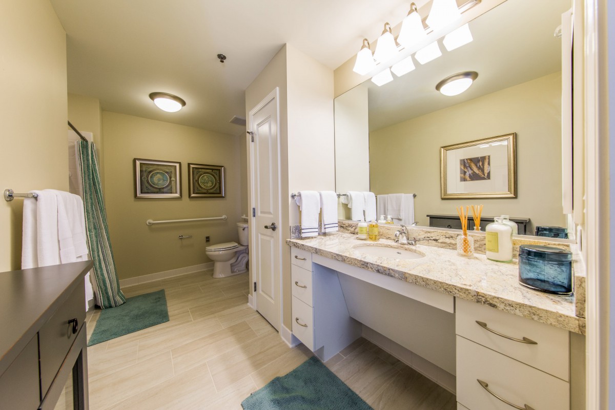 A modern bathroom with a spacious vanity and well-lit mirror.