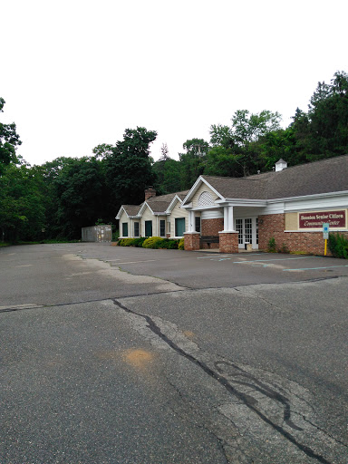 A quiet commercial building surrounded by greenery, set on a spacious lot.