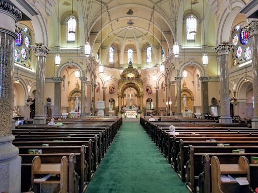 A serene interior view of a church, showcasing its elegant architecture and arrangement of pews leading to the altar.