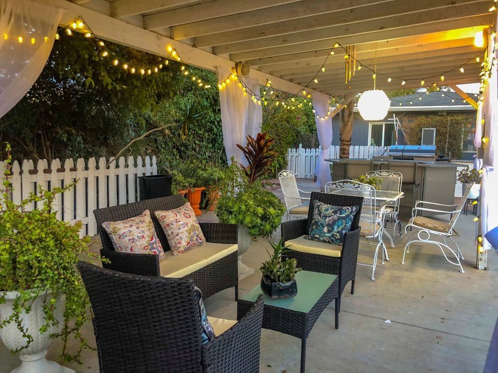 Cozy outdoor patio area with comfortable seating and string lights creating a warm ambiance.