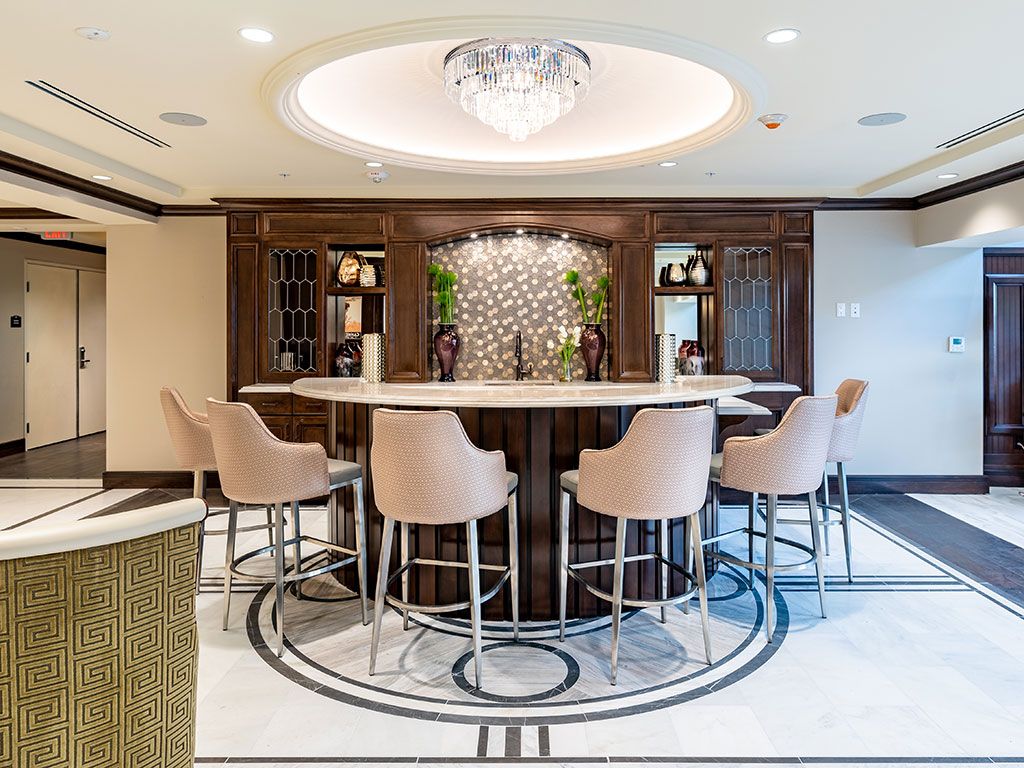 Elegant bar area with luxurious seating and a chandelier.