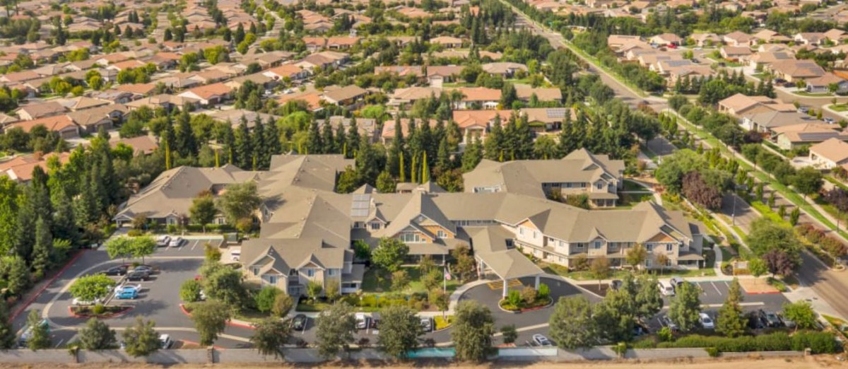 Aerial view of a residential neighborhood with houses and trees.