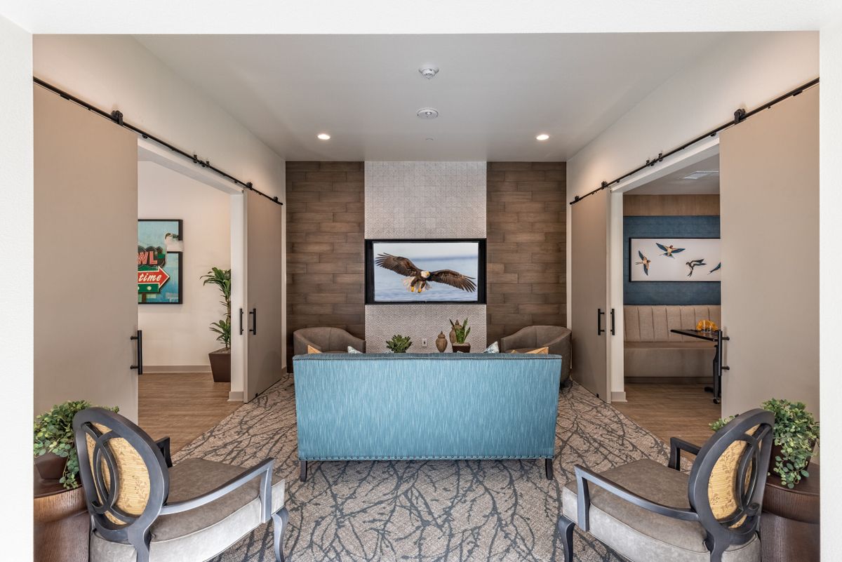 Modern lobby with seating area and decorative artwork.