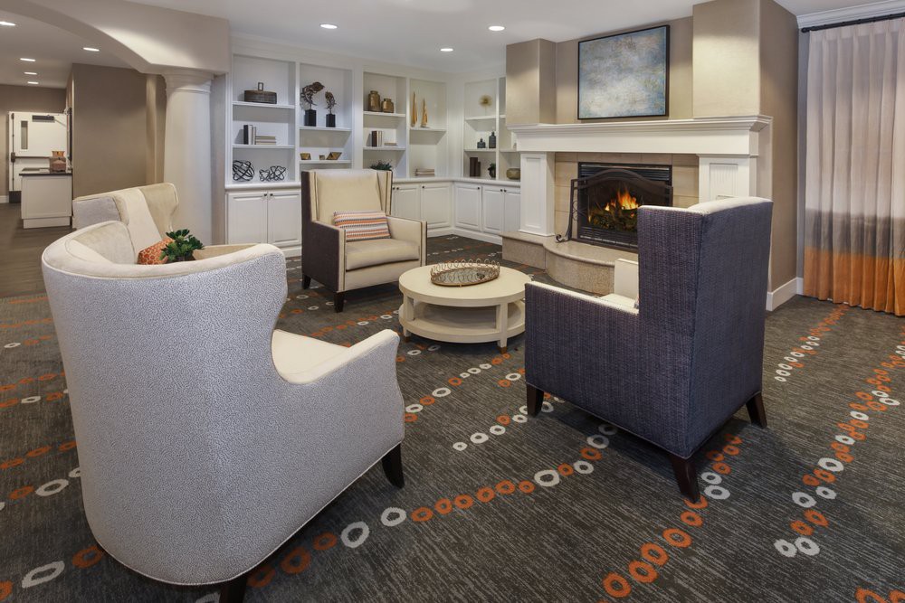 A cozy and modern living room with a fireplace and comfortable seating.