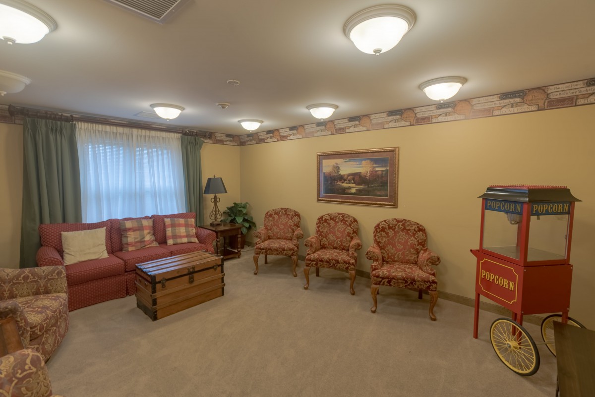 A cozy living room with multiple seating options and warm lighting.