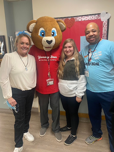 A joyful moment at the event with the mascot and attendees.