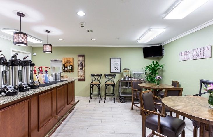 A cozy cafe with a bar counter, seating area, and modern decor.