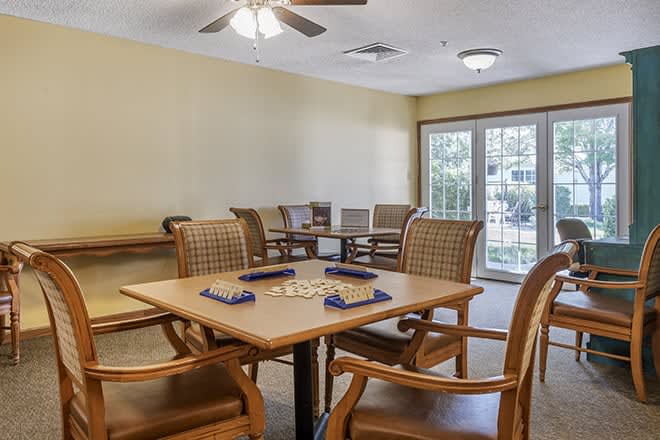 A cozy meeting room with a game set up on the table and comfortable seating.