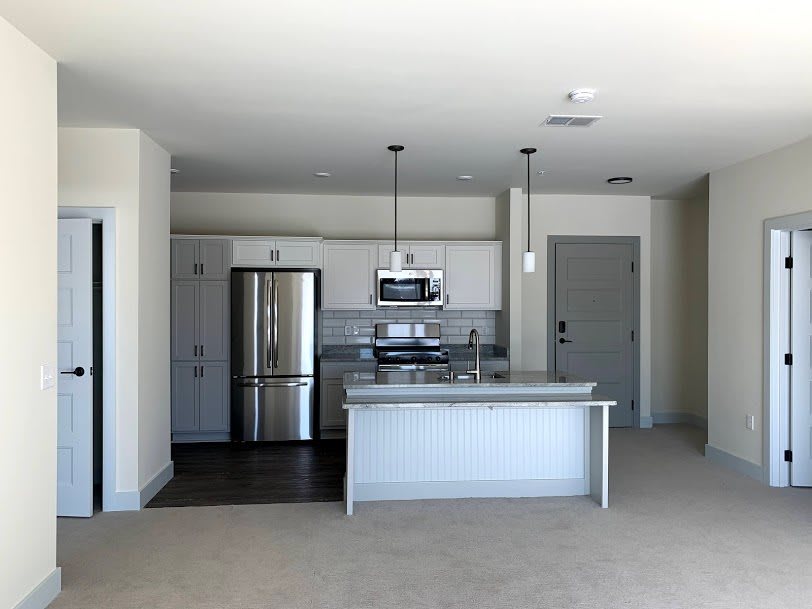 Modern kitchen with stainless steel appliances and an island counter.