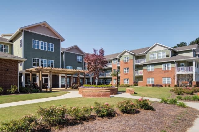 A view of a modern residential apartment complex with landscaped outdoor courtyard.