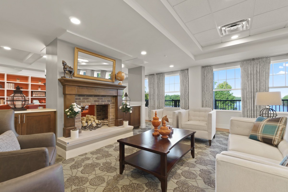 A well-lit living room with a cozy fireplace and elegant seating arrangement.