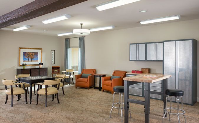 A modern lounge area featuring comfortable seating, tables, and ambient lighting.