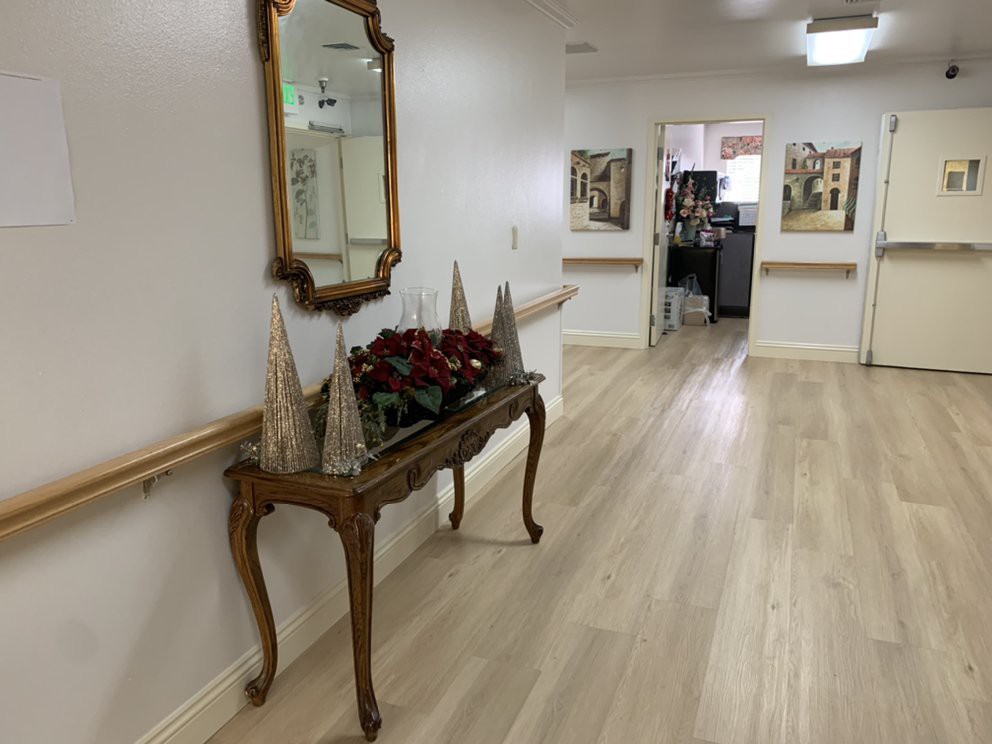 A hallway with a decorative console table and mirror, adorned with festive decor.