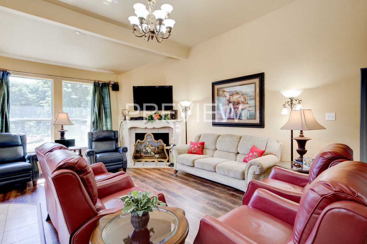 A cozy living room with comfortable seating, a fireplace, and elegant decor.