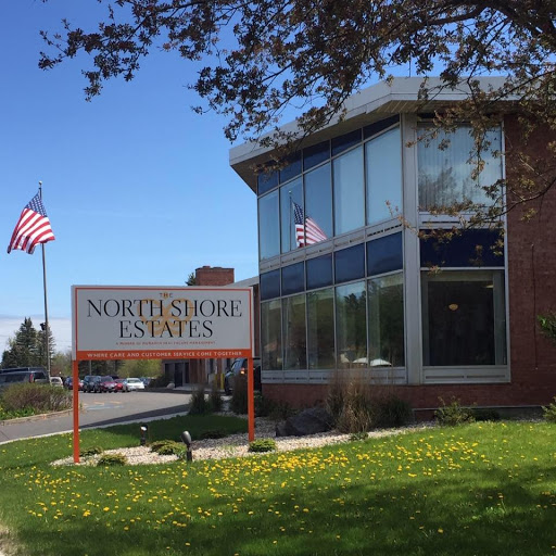 Northshore Estates building with an American flag in a sunny outdoor setting.