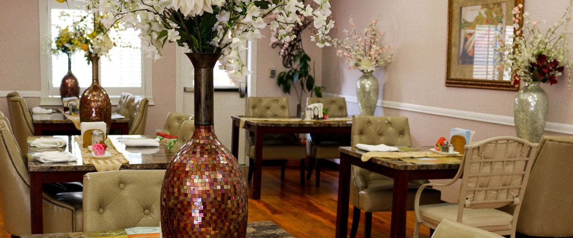 A cozy restaurant interior featuring elegant floral decor and neatly arranged tables.