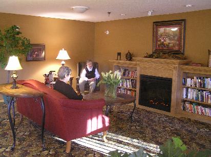 Two people having a conversation in a cozy living room with a fireplace.