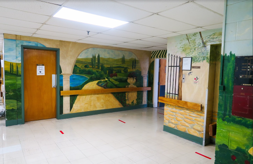 A vibrant mural depicting a serene landscape on the wall of a hallway.