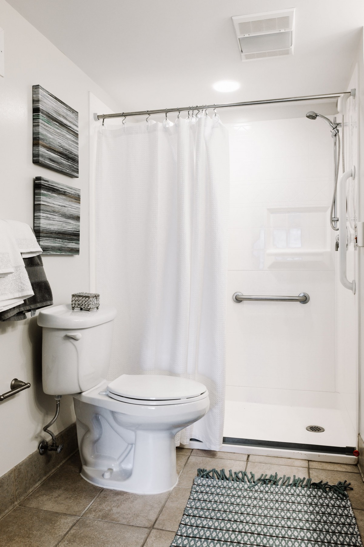 A clean and modern bathroom with a toilet and shower.