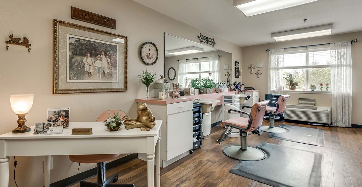 A cozy beauty salon interior with chairs, mirrors, and a variety of styling products.