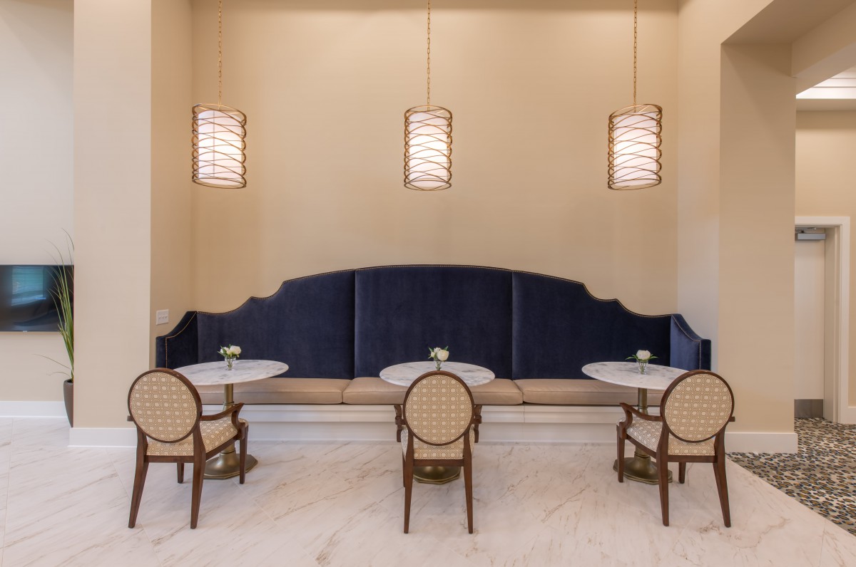A minimalist dining area with elegant lighting and seating arrangement.