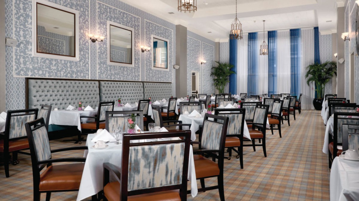 An elegantly designed restaurant dining room featuring neatly arranged tables and chairs.