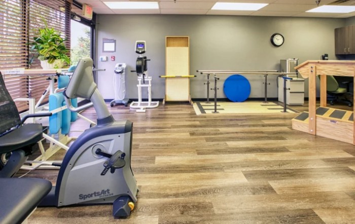 An indoor fitness center with a variety of exercise and rehabilitation equipment.