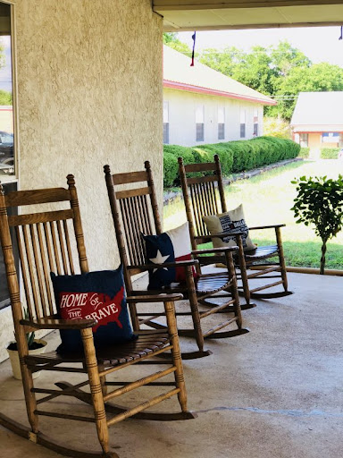 A serene porch with rocking chairs inviting relaxation on a sunny day.