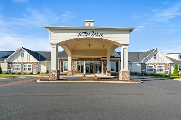 A large building with a grand entrance and clear blue skies.