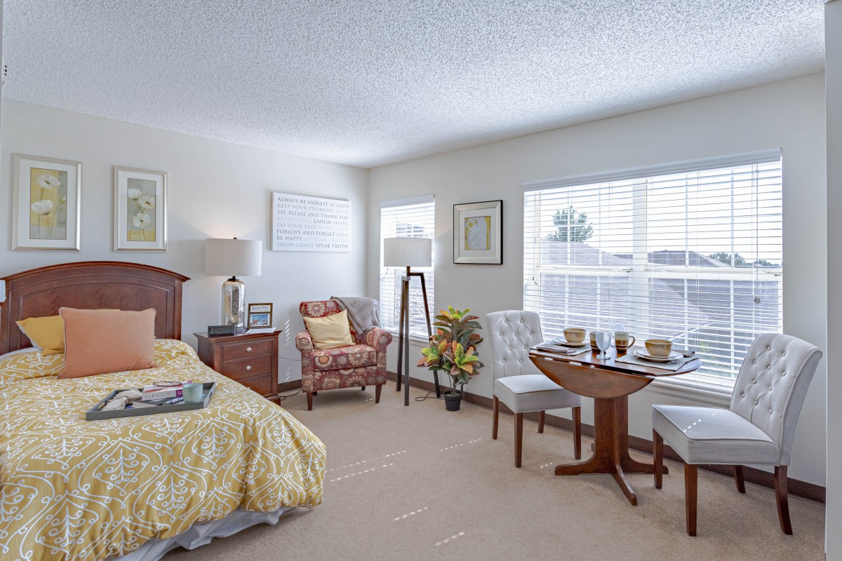 A cozy bedroom with elegant furniture and ample natural light.